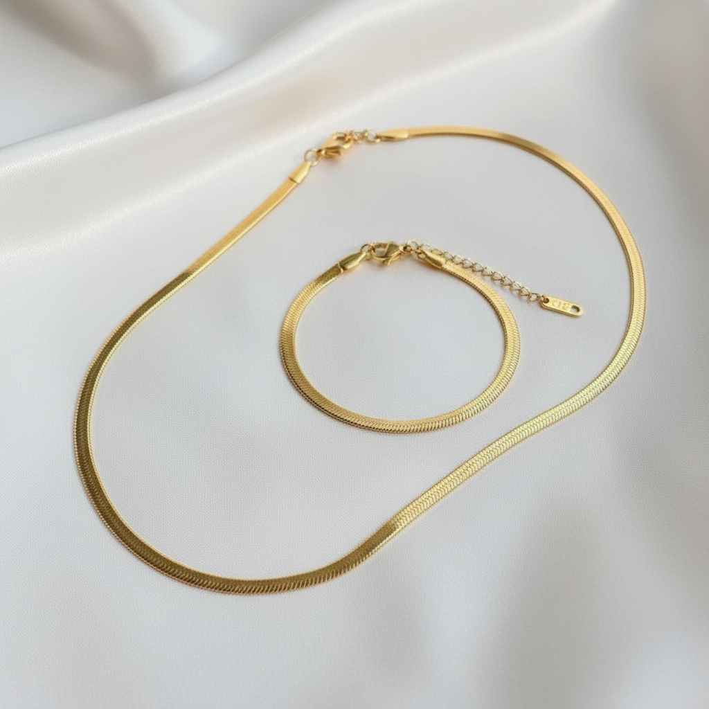 Gold snake chain necklace and bracelet set – flat lay on white silk, anti-tarnish matching jewellery India