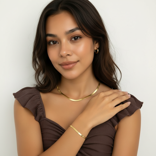 Woman wearing matching gold snake chain necklace and bracelet set – anti-tarnish everyday jewellery